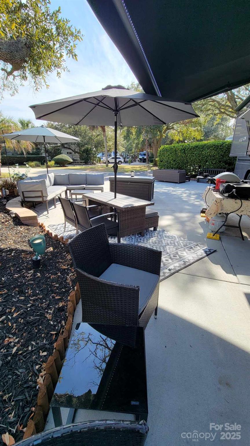 43B Jenkins Island Road, Unit 177 Hilton Head Island, SC 29926 - Photo 10 of 17 a view of a backyard with table and chairs under an umbrella