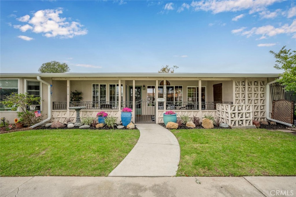 1621 Interlachen Road, Unit 265B Seal Beach, CA 90740 - Photo 1 of 36 a front view of a house with a yard and garden
