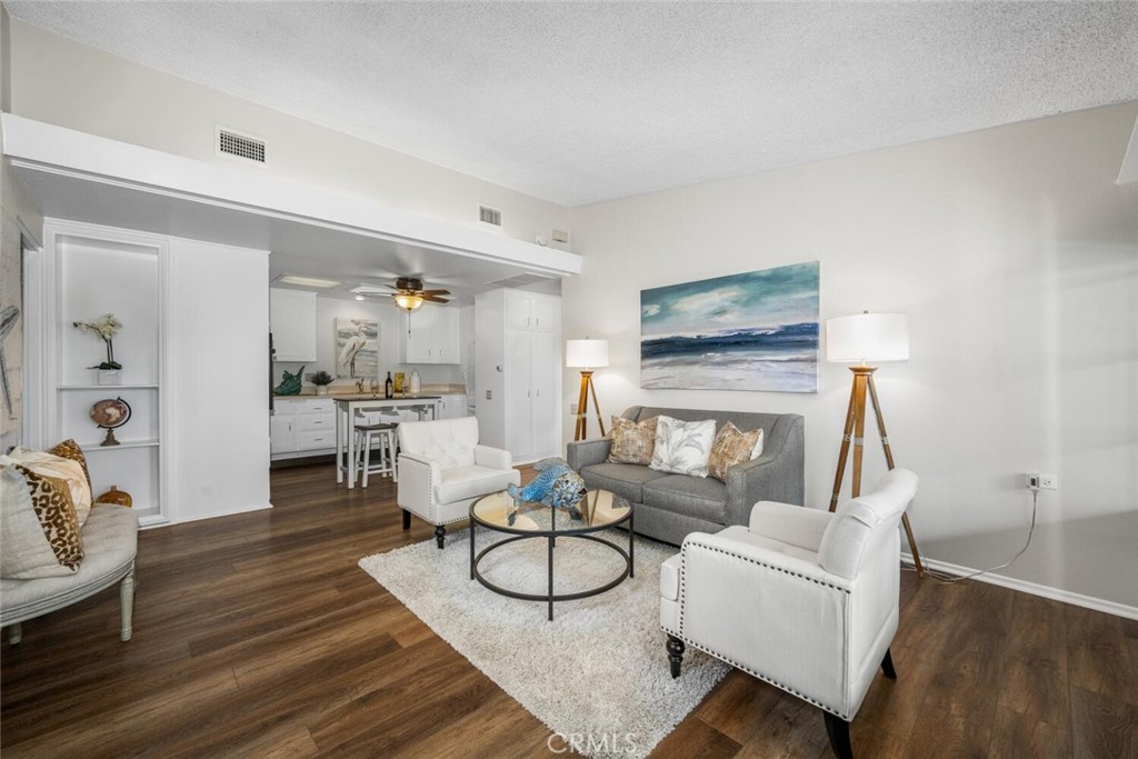1621 Interlachen Road, Unit 265B Seal Beach, CA 90740 - Photo 11 of 36 a living room with fireplace furniture and a wooden floor