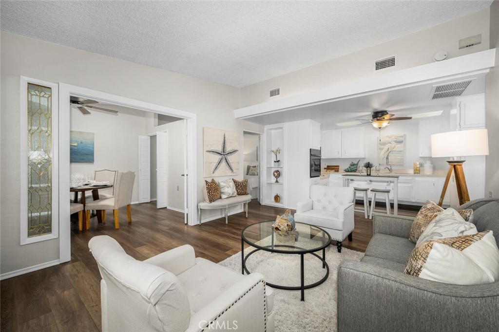 1621 Interlachen Road, Unit 265B Seal Beach, CA 90740 - Photo 12 of 36 a living room with furniture and a table