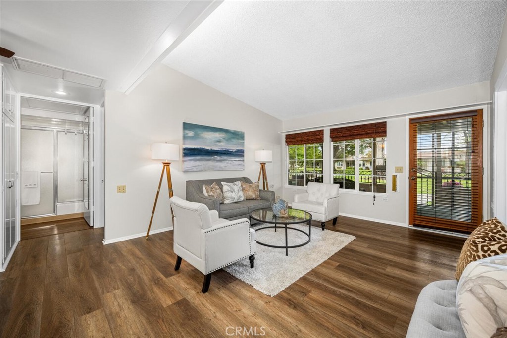 1621 Interlachen Road, Unit 265B Seal Beach, CA 90740 - Photo 14 of 36 a living room with furniture and a floor to ceiling window