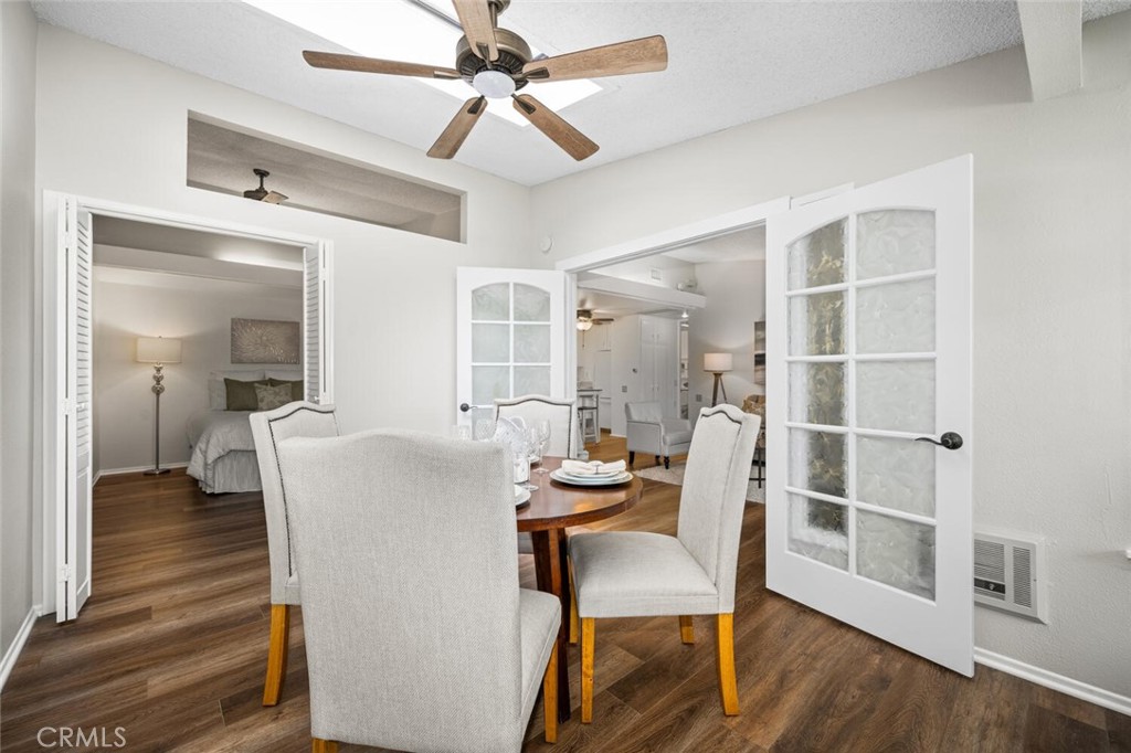 1621 Interlachen Road, Unit 265B Seal Beach, CA 90740 - Photo 20 of 36 a dining room with furniture and wooden floor