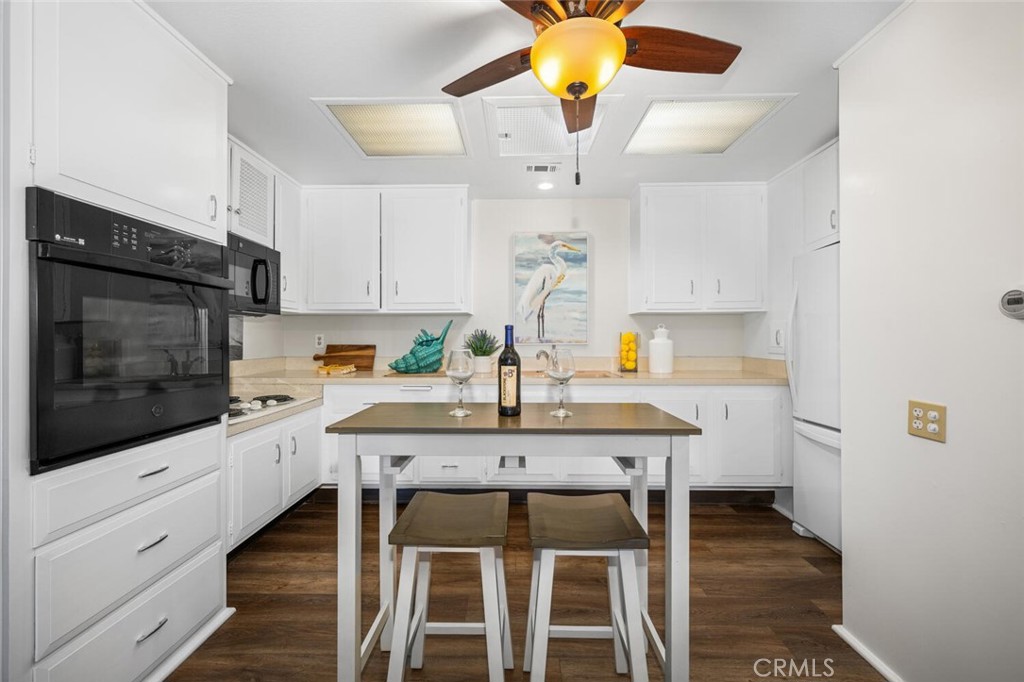 1621 Interlachen Road, Unit 265B Seal Beach, CA 90740 - Photo 22 of 36 a kitchen with a table chairs and entryway