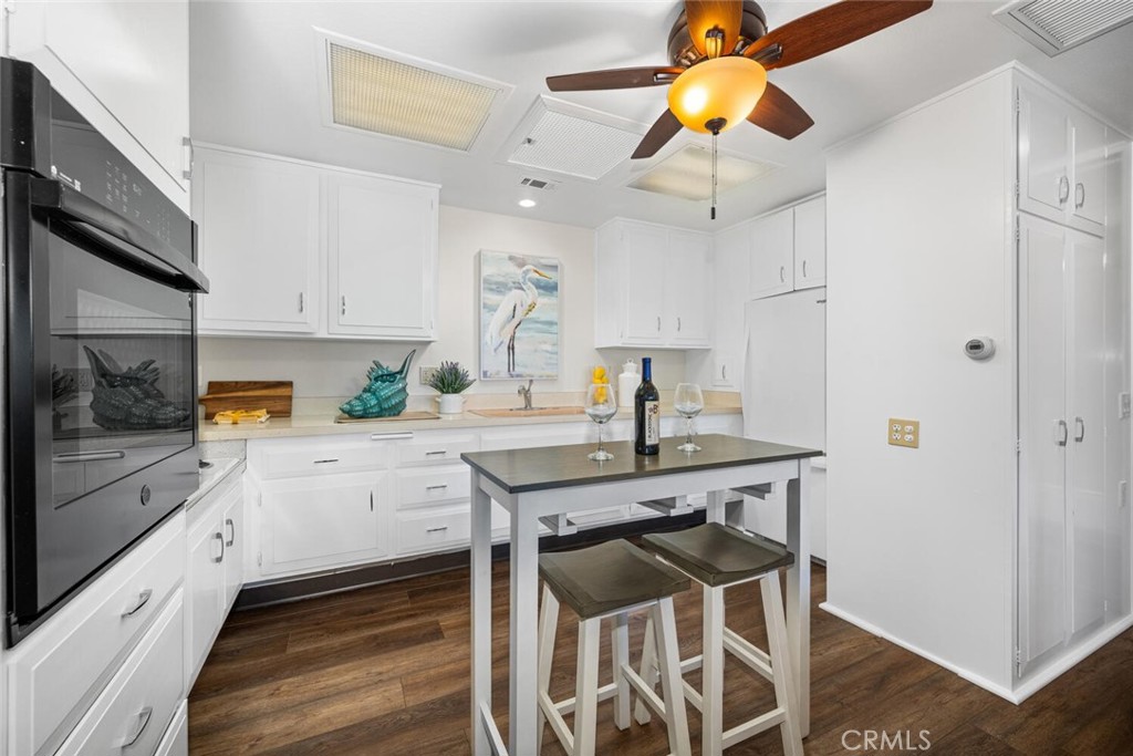 1621 Interlachen Road, Unit 265B Seal Beach, CA 90740 - Photo 23 of 36 a kitchen with a table and chairs