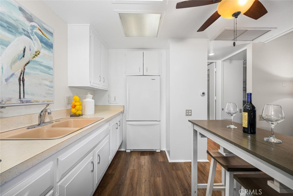 1621 Interlachen Road, Unit 265B Seal Beach, CA 90740 - Photo 24 of 36 a kitchen with a sink and cabinets
