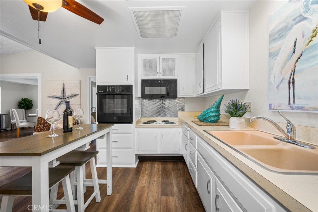 1621 Interlachen Road, Unit 265B Seal Beach, CA 90740 - Photo 26 of 36 a kitchen with a sink stove and cabinets