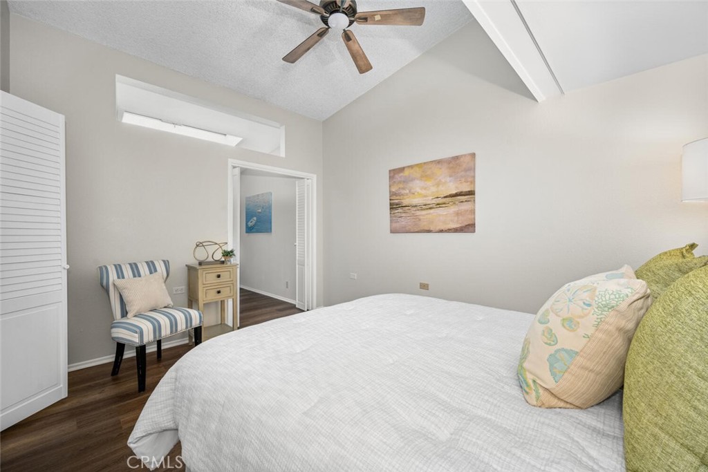 1621 Interlachen Road, Unit 265B Seal Beach, CA 90740 - Photo 30 of 36 a bedroom with a bed and a chair
