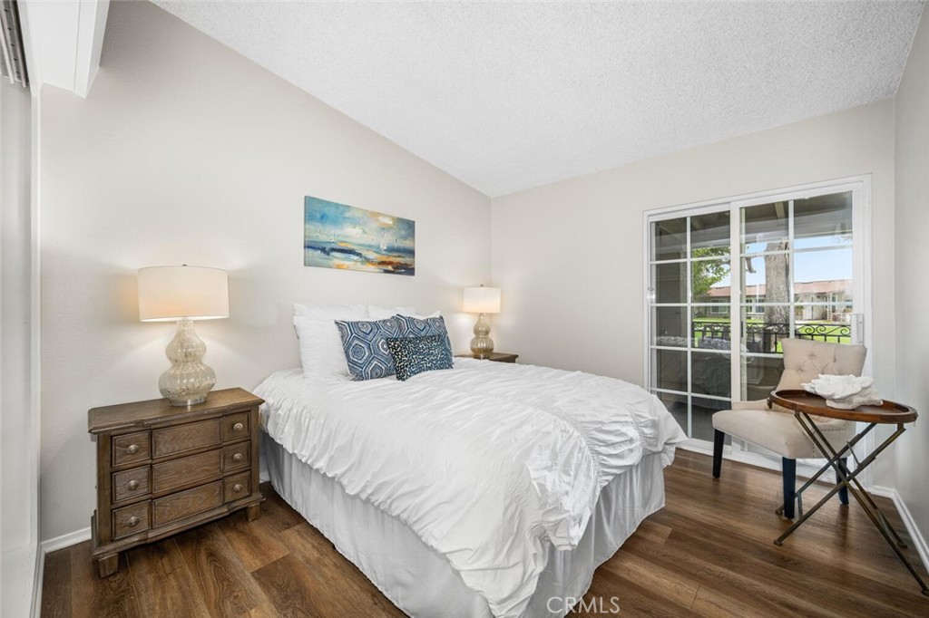 1621 Interlachen Road, Unit 265B Seal Beach, CA 90740 - Photo 33 of 36 a bedroom with a bed and wooden floor