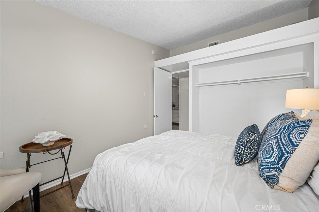 1621 Interlachen Road, Unit 265B Seal Beach, CA 90740 - Photo 35 of 36 a bedroom with a bed and chair