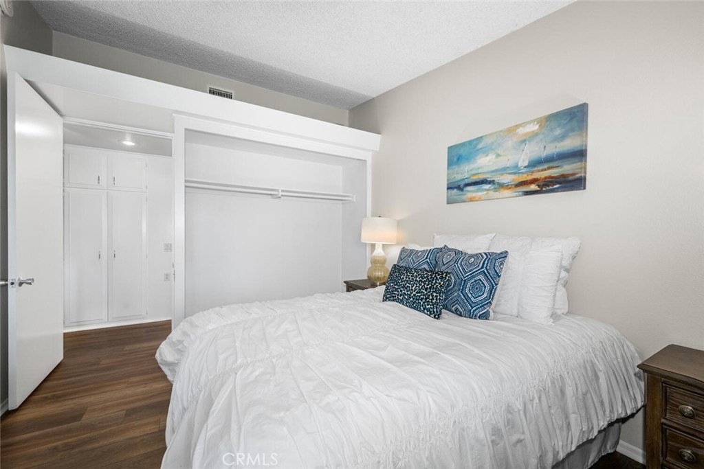 1621 Interlachen Road, Unit 265B Seal Beach, CA 90740 - Photo 36 of 36 a bedroom with a bed and wooden floor