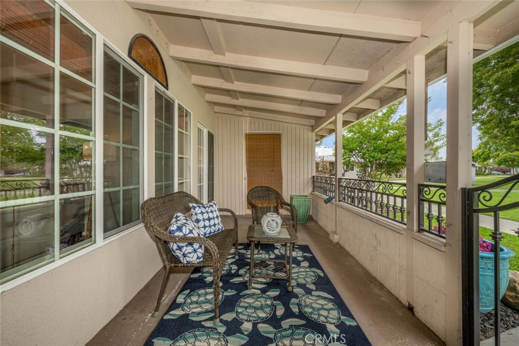 1621 Interlachen Road, Unit 265B Seal Beach, CA 90740 - Photo 7 of 36 a balcony with chairs and couch