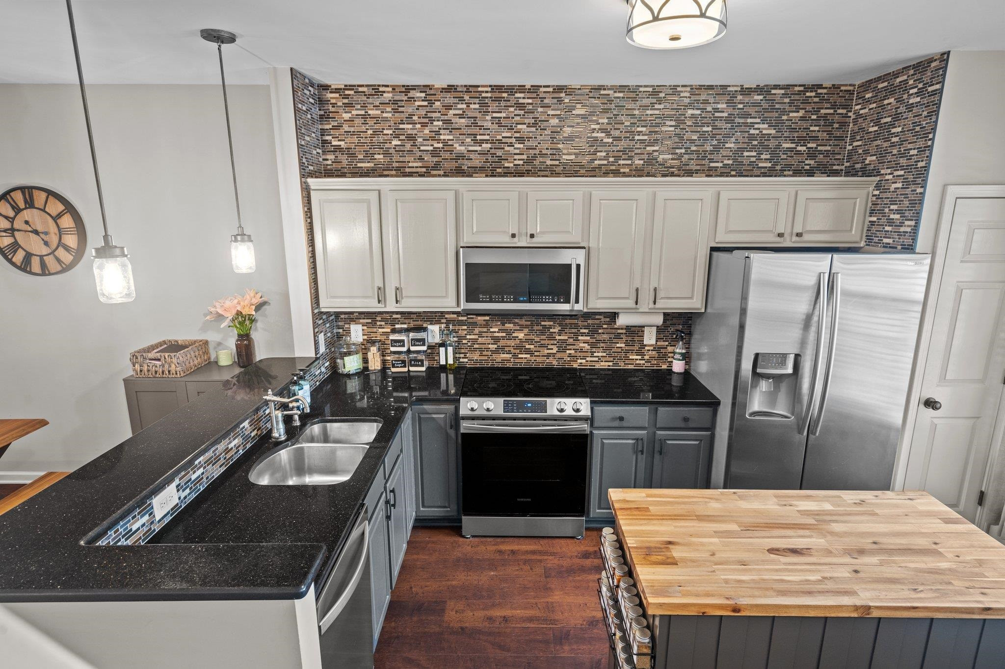 1750 Sorrell Brook Way Raleigh, NC 27609 - Photo 11 of 32 a kitchen with granite countertop a refrigerator stove and sink