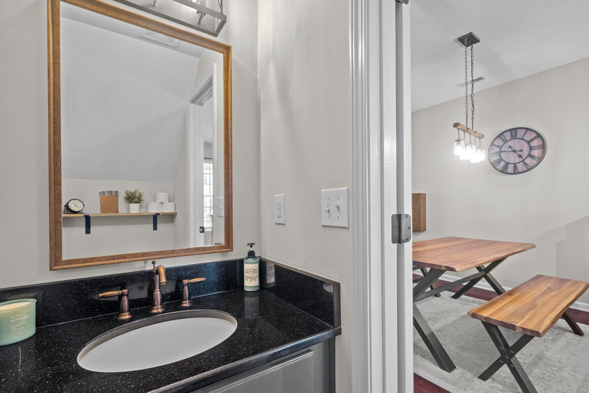 1750 Sorrell Brook Way Raleigh, NC 27609 - Photo 12 of 32 a en suite bathroom with a granite countertop sink and a mirror