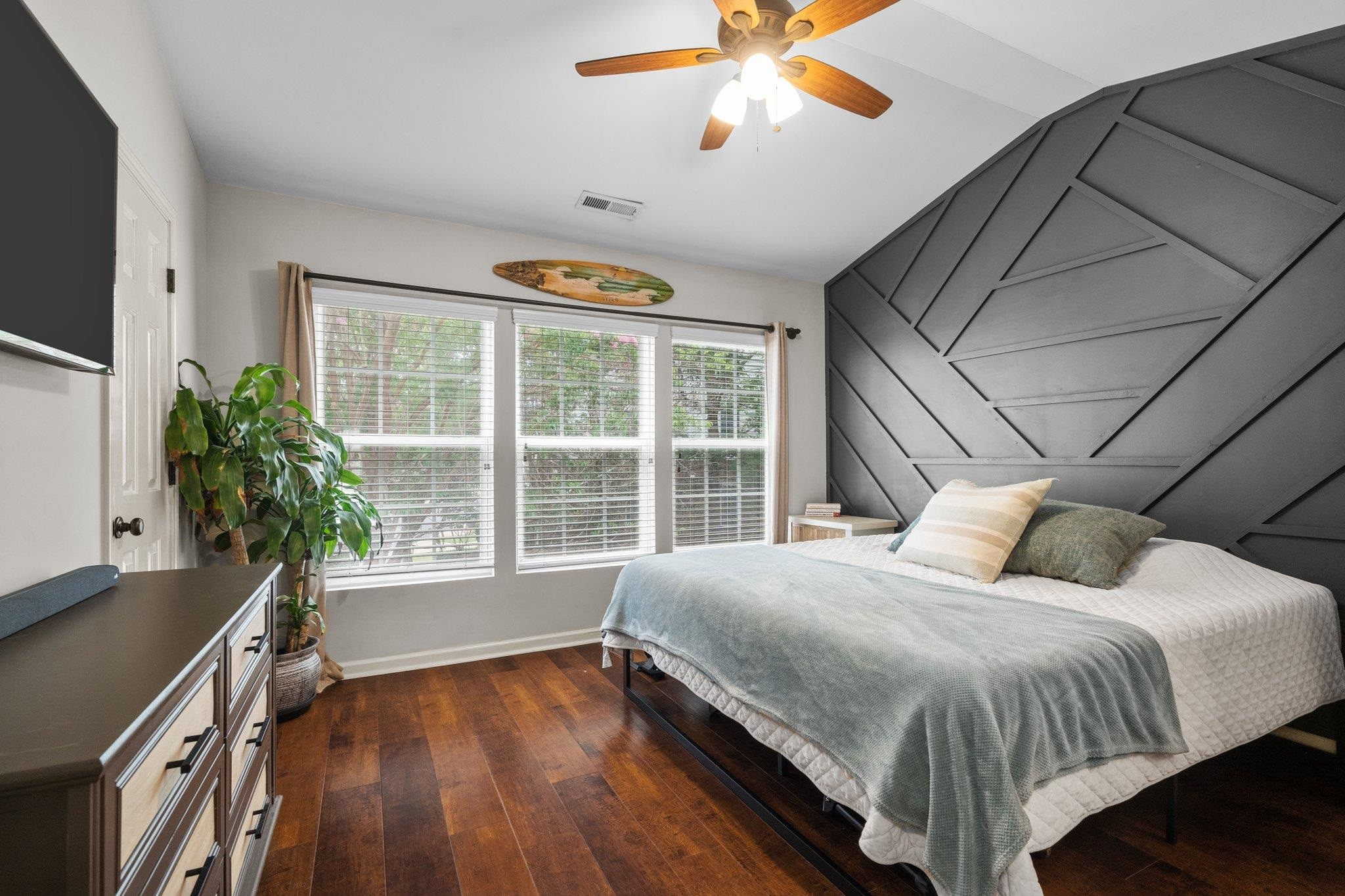 1750 Sorrell Brook Way Raleigh, NC 27609 - Photo 20 of 32 a bedroom with a large bed and a chandelier