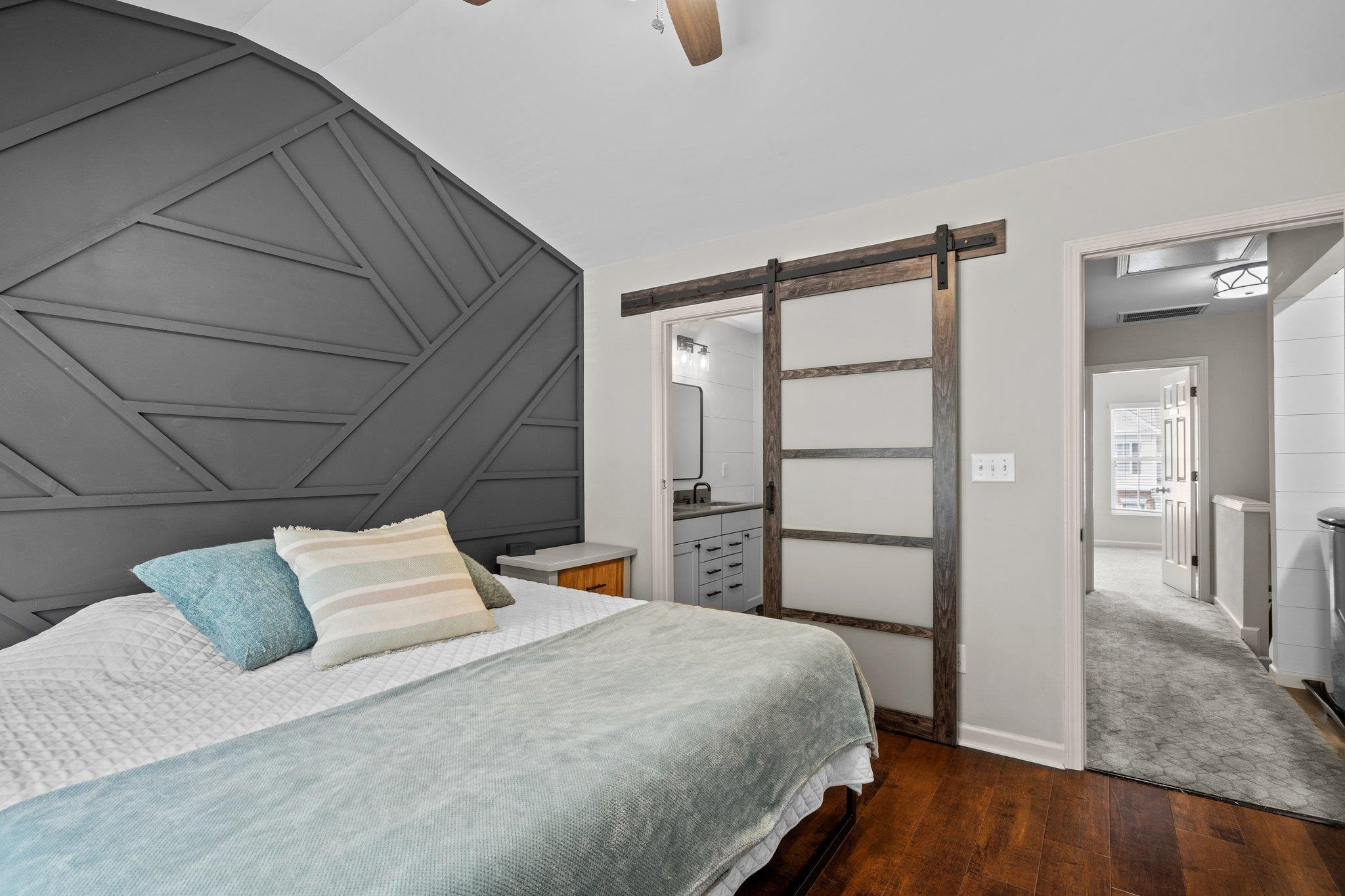 1750 Sorrell Brook Way Raleigh, NC 27609 - Photo 22 of 32 a bedroom with a bed and wooden floor