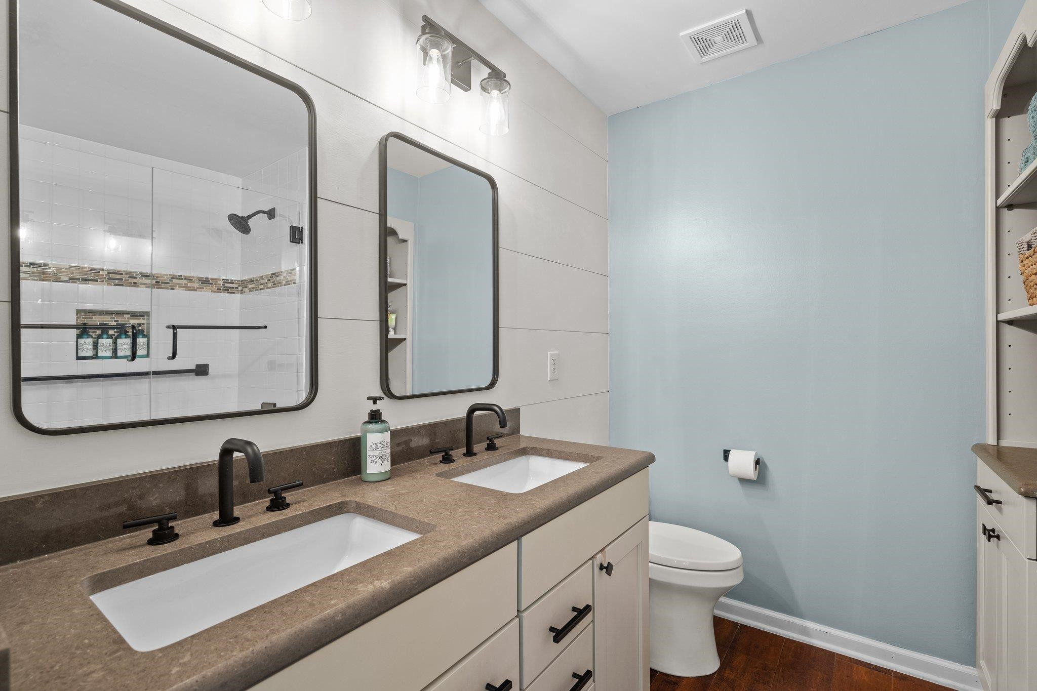 1750 Sorrell Brook Way Raleigh, NC 27609 - Photo 23 of 32 a bathroom with a toilet sink double vanity and mirror