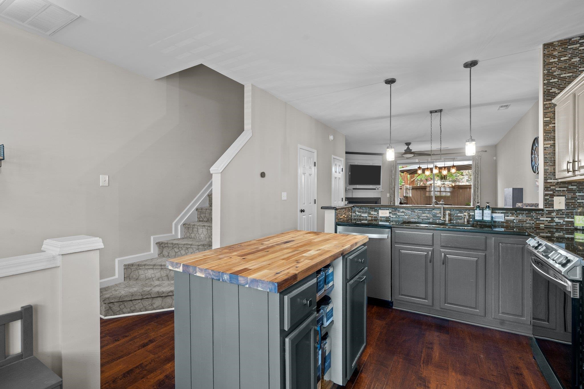 1750 Sorrell Brook Way Raleigh, NC 27609 - Photo 6 of 32 a kitchen with stainless steel appliances granite countertop a stove a sink and a refrigerator