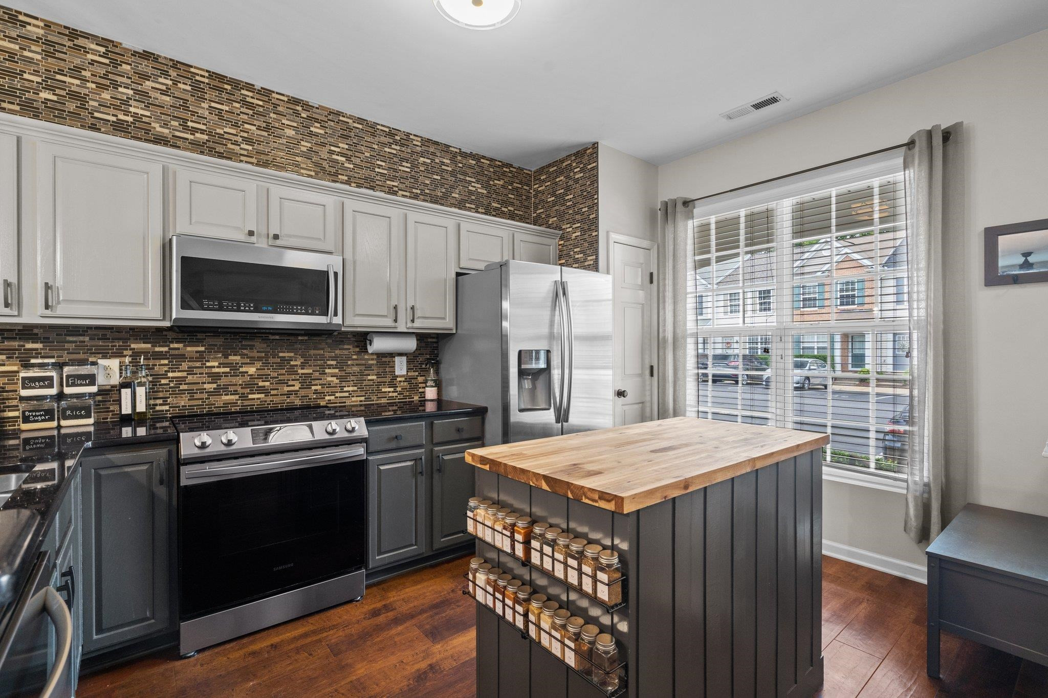 1750 Sorrell Brook Way Raleigh, NC 27609 - Photo 8 of 32 a kitchen with a stove a sink and a refrigerator