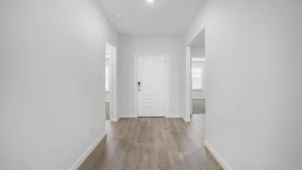 a view of a hallway with wooden floor