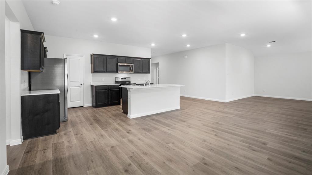 1921 Reveille Way Terrell, TX 75160 - Photo 24 of 25 a view of kitchen with stainless steel appliances granite countertop a refrigerator and a stove top oven