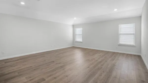 a kitchen with a sink cabinets and wooden floor