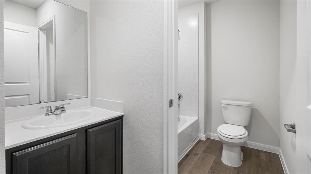 1921 Reveille Way Terrell, TX 75160 - Photo 2 of 25 a bathroom with a sink a toilet and a mirror