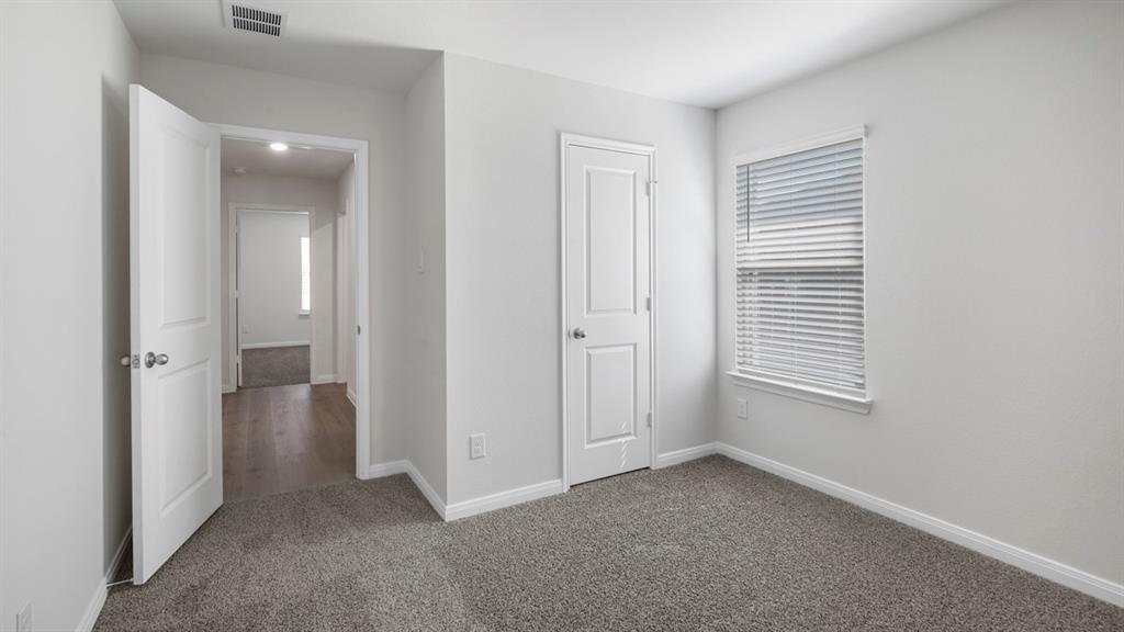 1921 Reveille Way Terrell, TX 75160 - Photo 8 of 25 an empty room with windows and closet