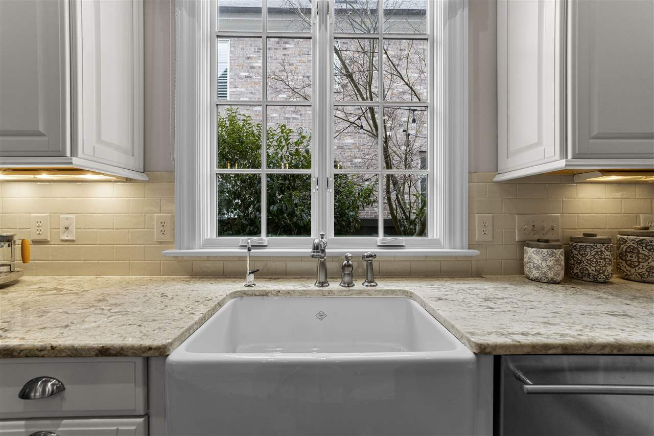 503 Guilford Circle Raleigh, NC 27608 - Photo 10 of 28 A deep kitchen sink with a lovely casement window overlooks the back patio + deck. Kitchen