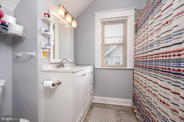 a bathroom with a sink a vanity and a mirror
