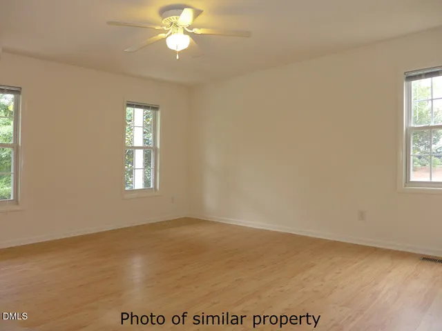 a view of wooden floor and windows in a room