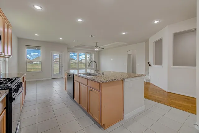 a kitchen with stainless steel appliances granite countertop a refrigerator sink and cabinets