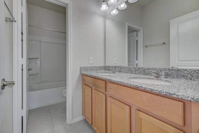 en empty room with windows and fan