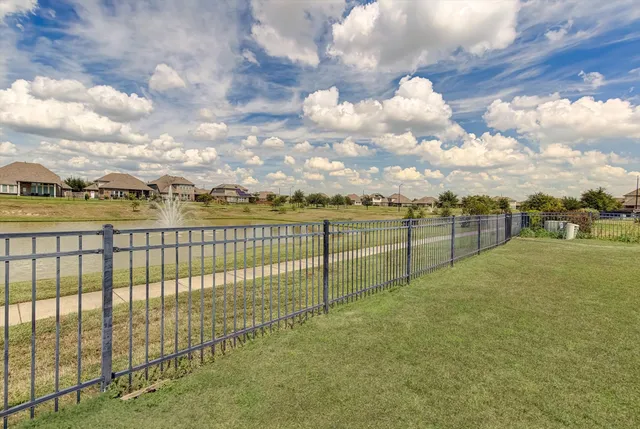 a view of outdoor space with iron fence