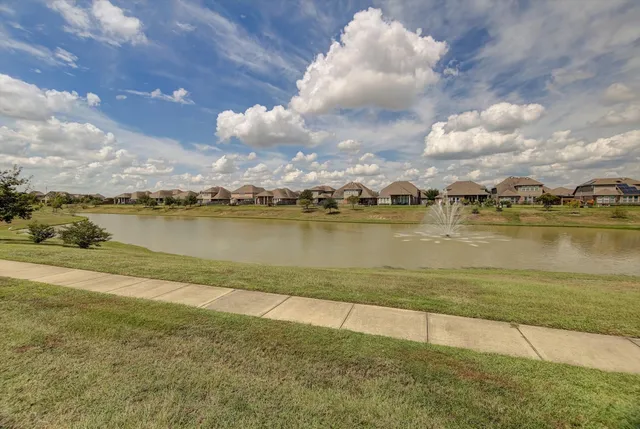 a view of a lake with houses in the background