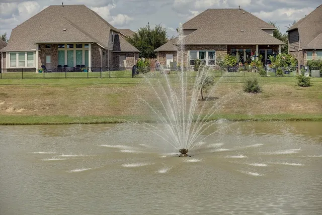 an aerial view of a residential houses with outdoor space and swimming pool