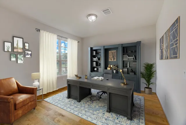 an empty room with wooden floor and window