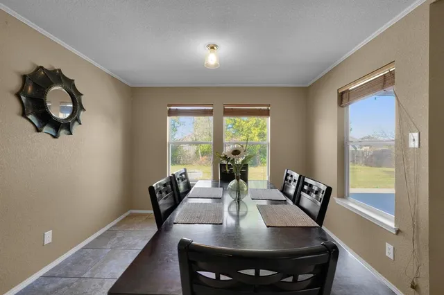 a view of a dining room with furniture window and outside view