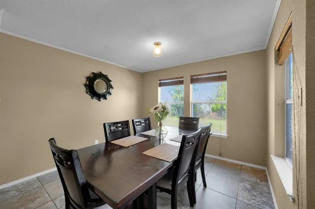 a view of a dining room with furniture and window