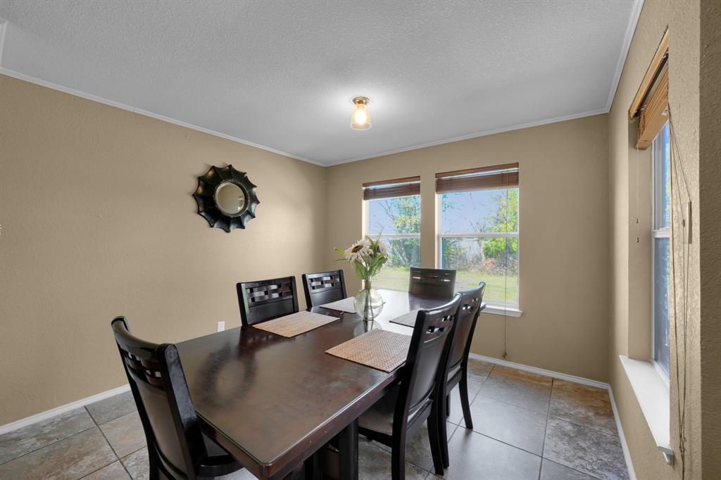 951 Behrens Court Crowley, TX 76036 - Photo 19 of 37 a view of a dining room with furniture and window