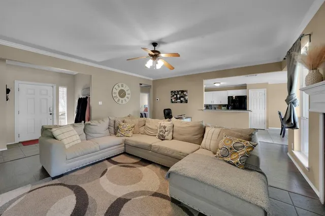 a living room with furniture and a view of kitchen