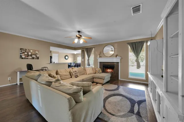 a living room with furniture a fireplace and a large window