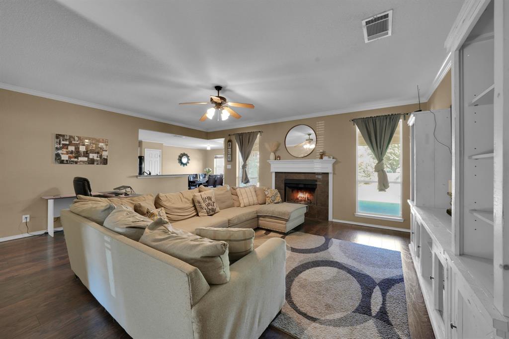 951 Behrens Court Crowley, TX 76036 - Photo 22 of 37 a living room with furniture a fireplace and a large window