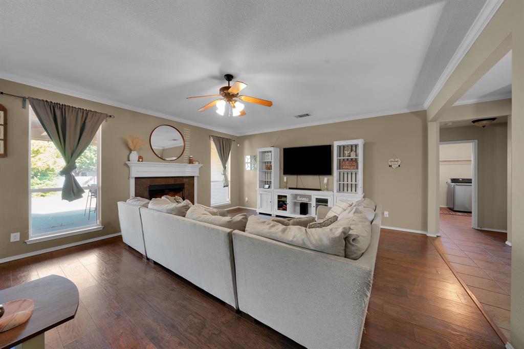 951 Behrens Court Crowley, TX 76036 - Photo 23 of 37 a living room with furniture a fireplace and a flat screen tv