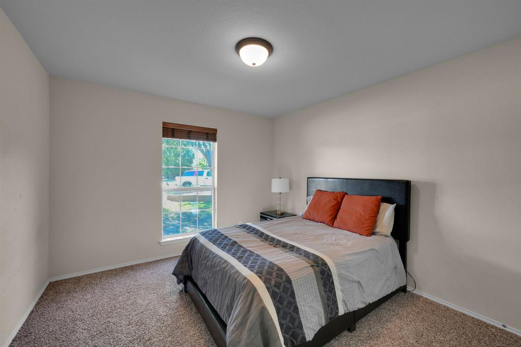 951 Behrens Court Crowley, TX 76036 - Photo 26 of 37 a bedroom with a bed and a window