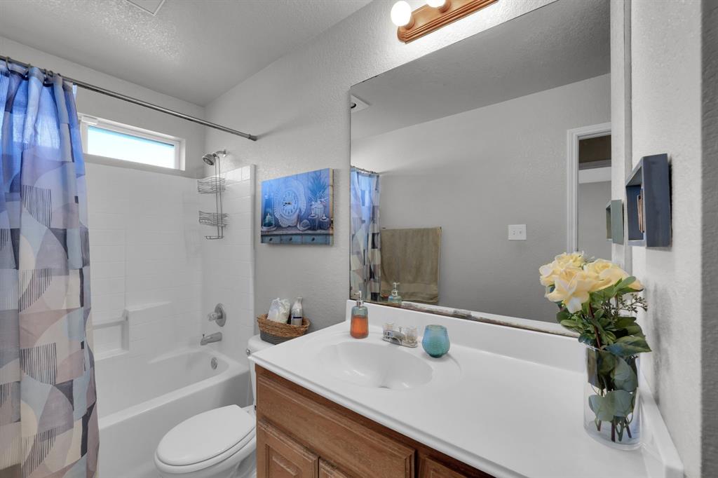 951 Behrens Court Crowley, TX 76036 - Photo 27 of 37 a bathroom with a sink a toilet and bathtub