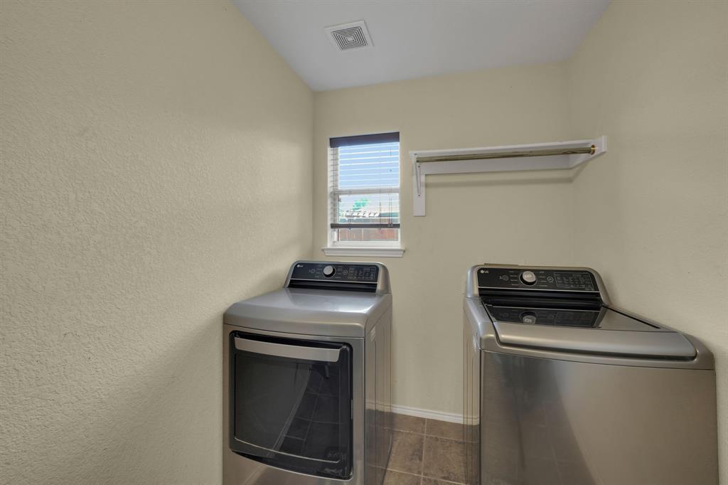951 Behrens Court Crowley, TX 76036 - Photo 30 of 37 a kitchen with a stove and a microwave