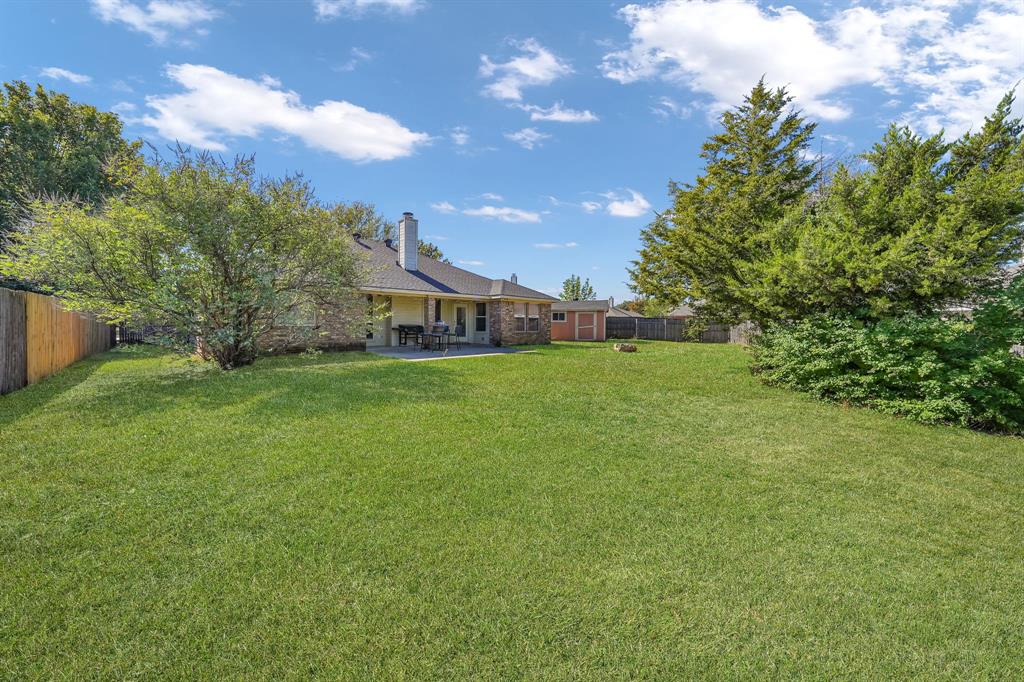 951 Behrens Court Crowley, TX 76036 - Photo 35 of 37 a view of a big yard with plants and large trees