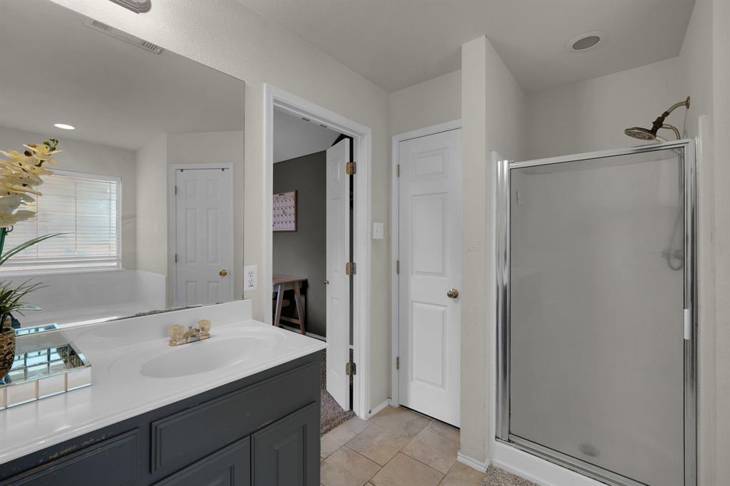 951 Behrens Court Crowley, TX 76036 - Photo 9 of 37 a bathroom with a sink and a mirror