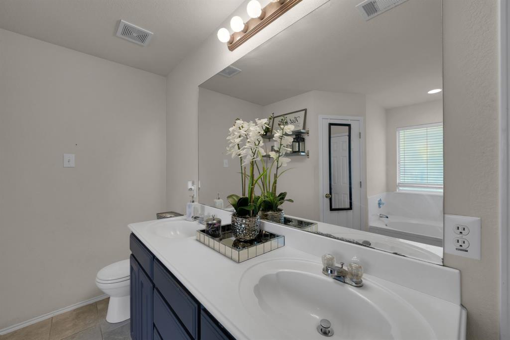 951 Behrens Court Crowley, TX 76036 - Photo 10 of 37 a bathroom with a sink and a mirror