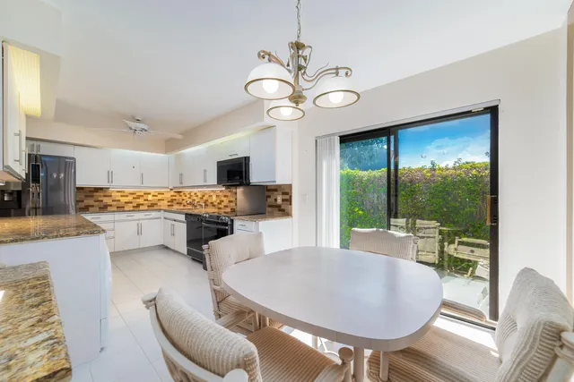 an aerial view of a houses with a lake